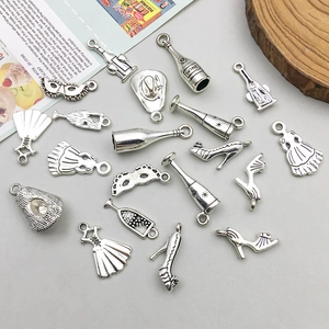 Detailed view of assorted antique silver alloy wine charms with intricate embossed textures