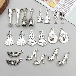 Macro view of antique silver alloy wine bottle and party charms for DIY jewelry making