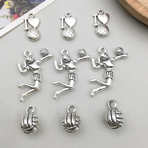 Detailed macro view of antique silver volleyball player alloy charms for DIY jewelry making