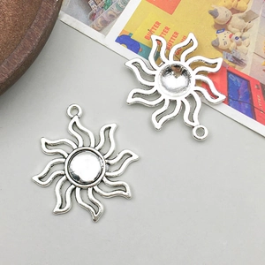 Detail of antique silver sun charms showing front and concave back texture for DIY jewelry