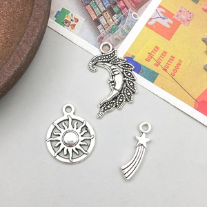 Detail of vintage silver celestial alloy charms featuring sun moon and star motifs