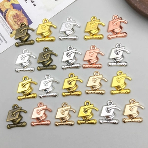 Macro shot of doctoral cap alloy pendants in bronze, gold, and silver for DIY jewelry