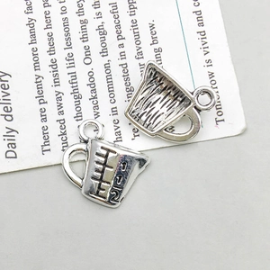 Detail of antique silver measuring cup pendants with scales for DIY jewelry making