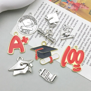 Handmade graduation alloy charms including diploma scroll and graduation day pendants