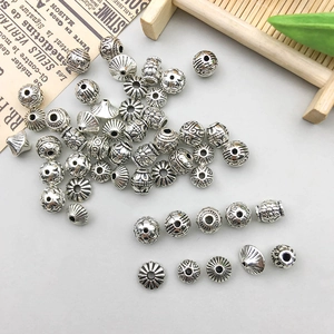 Macro di perle distanziatrici in lega d'argento con motivi floreali e geometrici vintage