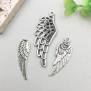 Three antique silver wing pendants in hollow and rose designs for DIY jewelry making