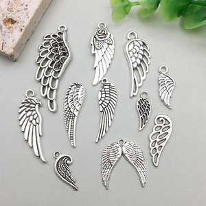 Antique silver alloy wing pendants set with detailed hollow feather designs for DIY jewelry