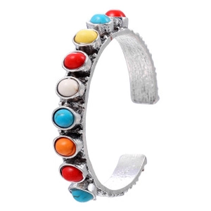 Detail view of vintage silver cuff bracelet with colorful stones and oxidized finish