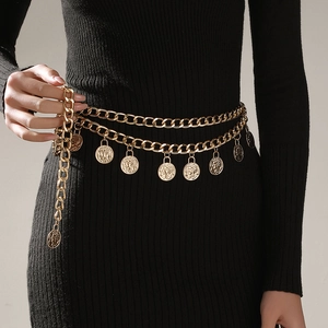 Close-up of gold layered chain belt with vintage coin pendants on black dress