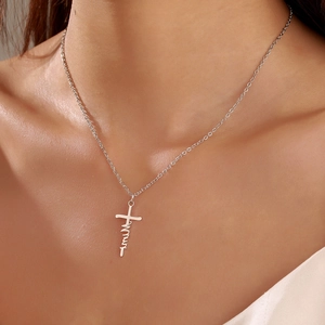Minimalist silver stainless steel Faith cross necklace shown on a model neck