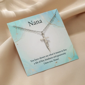 Silver stainless steel Nana cross necklace displayed on a marble textured gift card