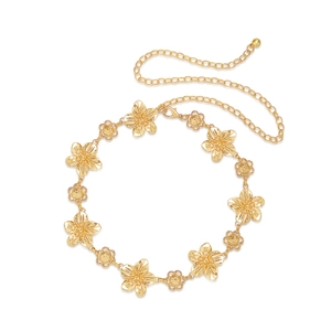 Close-up of golden vintage floral waist chain with intricate carved flower pendants