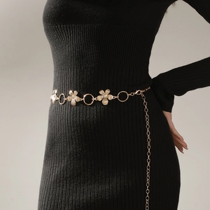 Close-up of gold metal waist chain with floral carvings and adjustable lobster clasp