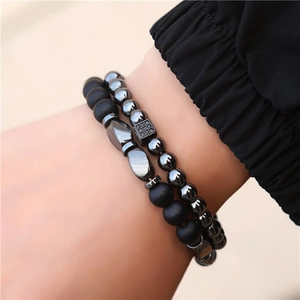 Detail of double-layer beaded bracelet featuring polished hematite and matte black stones