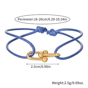 Blue braided couple bracelet with golden horseshoe buckle on a white background