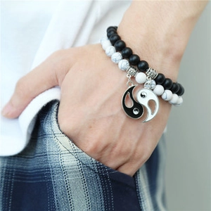 Detail of Yin Yang couple bracelets with black and white beads on a wrist