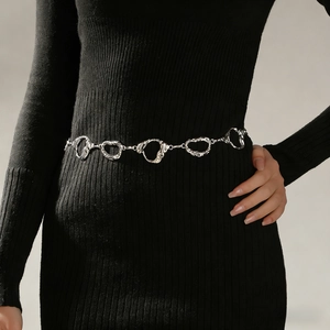 Close-up of vintage silver carved pendant waist chain with liquid metal texture tassels