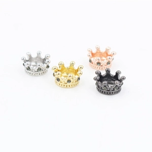 Macro shot of crown beads for jewelry DIY in four metallic finishes with dark rhinestones