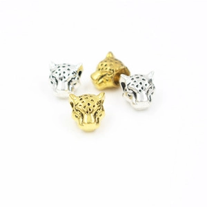 Detailed view of alloy leopard head spacer beads in gold and silver for DIY jewelry