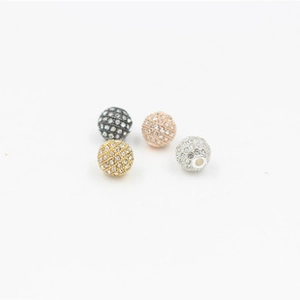 Macro detail of spherical rhinestone spacer beads in gold and silver for DIY jewelry