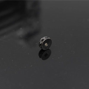 Macro detail of a black plated round spacer bead with pavé-set black crystals for jewelry DIY