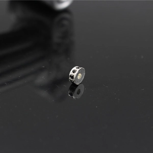 Macro shot of a silver spacer bead with black rhinestones for DIY jewelry making
