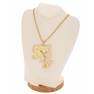 Detailed shot of golden Egyptian falcon wing pendant on a box chain display