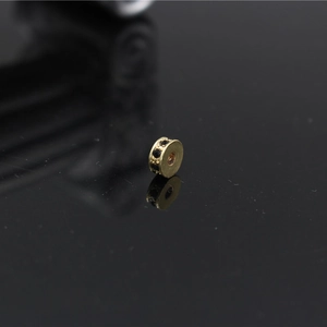 Macro view of a gold plated spacer bead with black zircon inlay for DIY jewelry