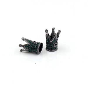 Macro detail of gunmetal crown beads with green rhinestones for DIY jewelry making