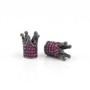 Macro view of crown beads in gunmetal finish with magenta rhinestones for DIY jewelry