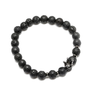 Close-up of black lava stone beads with micro-pave crown charm on men's beaded bracelet