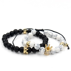 Close-up of beaded crown bracelets with white marble stone and black lava rock beads