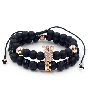 Detail of beaded crown bracelets featuring black lava stones and rose gold accents