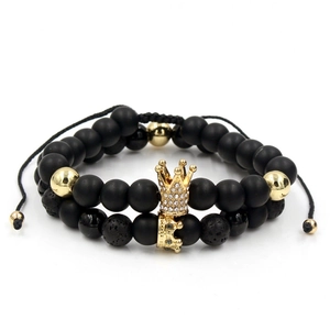 Detail view of adjustable braided bracelets with lava stone beads and gold crown charms