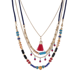 Detailed view of bohemian multilayer necklace with colorful beads and red fringe tassels