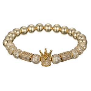 Detail of luxury gold beaded bracelet featuring micro-pave crown and zircon stone beads
