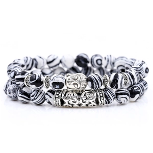 Detail of marble pattern beads and silver Buddha head charms on a bracelet set