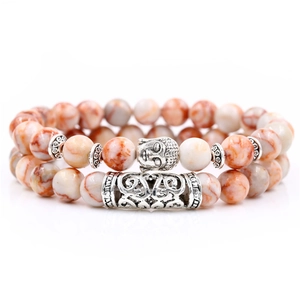 Detail of beaded bracelet set featuring Buddha head and hollow tube with marble stone beads