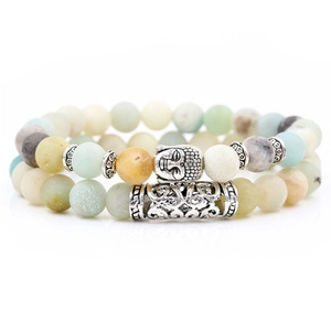Detail of natural energy stone beaded bracelets with silver Buddha head and tube accents