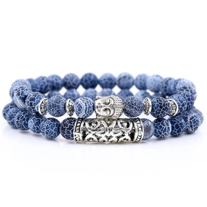 Detail of blue energy stone beads with silver Buddha head and cylinder tube charms