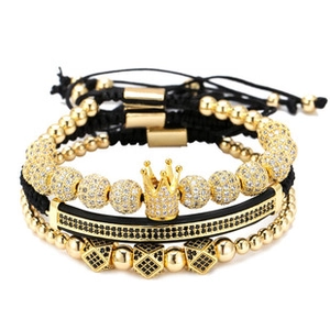 Men's luxury black and gold bracelet set featuring a gold crown and cubic zirconia beads