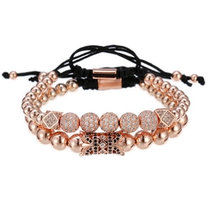 Detail of rose gold beaded bracelets with micro-paved crystals and adjustable black cords