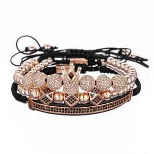 Macro view of rose gold bracelet set with crown pendant and black crystal inlay