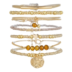 Bohemian 7-piece gold and brown beaded bracelet set with heart charms and metallic discs