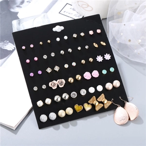 Macro shot of a 30-pair fashion earring set featuring hearts, bows and colorful studs