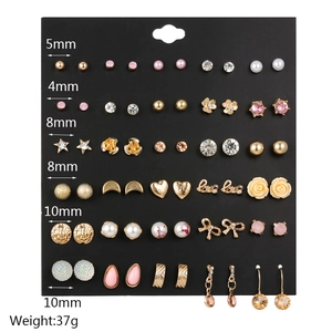 Detailed view of 30 pairs of gold and pearl stud earrings set with multiple designs