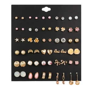 Detailed display of 30 pairs trendy gold and pink earrings set on black card organizer