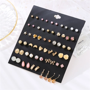 Detail of 30-pair earring set featuring gold-tone metal, pearls and rhinestones on card