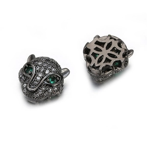 Copper leopard head bead with white zircon inlay and green gem eyes on white background