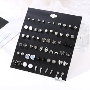 Detail of 30 pairs earring set with pearls and rhinestones on black display card